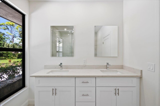 bathroom featuring vanity and a shower with door