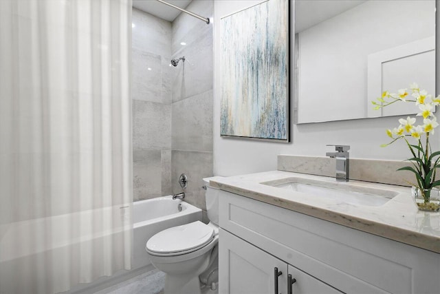 full bathroom with vanity, tiled shower / bath combo, and toilet