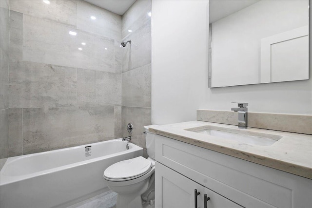 full bathroom with vanity, toilet, and tiled shower / bath