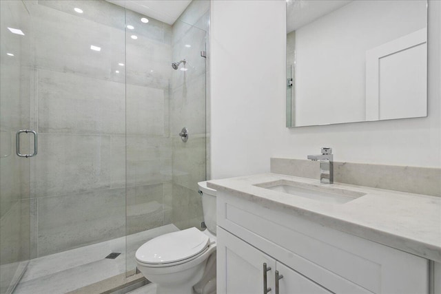 bathroom featuring walk in shower, vanity, and toilet