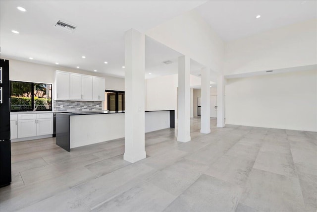 kitchen featuring decorative backsplash and white cabinets