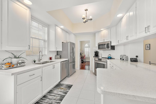 kitchen featuring light tile patterned floors, stainless steel appliances, sink, and white cabinets