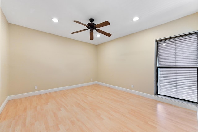 spare room featuring ceiling fan, recessed lighting, light wood-style flooring, and baseboards