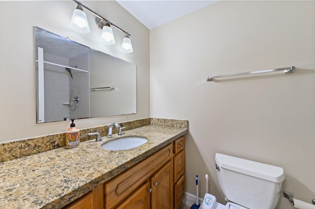 full bathroom featuring toilet, baseboards, a shower, and vanity