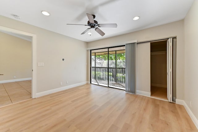 unfurnished bedroom featuring recessed lighting, baseboards, access to exterior, and light wood-style floors