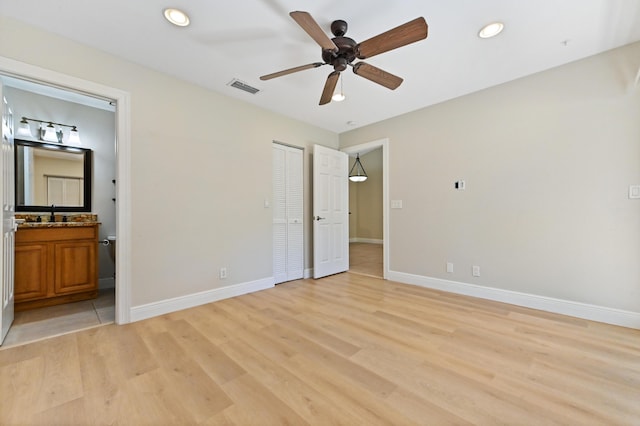 unfurnished bedroom featuring light wood finished floors, baseboards, visible vents, and recessed lighting