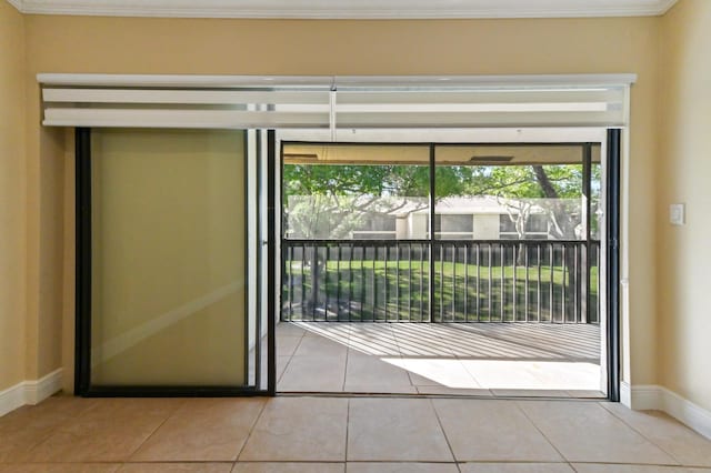 doorway to outside featuring light tile patterned floors, baseboards, and ornamental molding