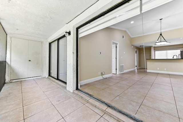 3939 NE 5th Ave Unit A206, Boca Raton, FL 33431 - unfurnished room with light tile patterned floors, ornamental molding, baseboards, and lofted ceiling