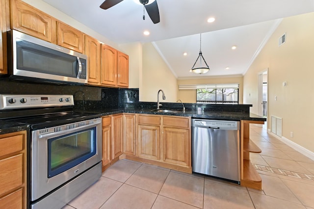 kitchen with stainless steel appliances, a peninsula, a sink, vaulted ceiling, and crown molding