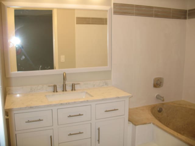 full bathroom with vanity and washtub / shower combination