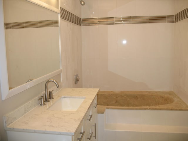 bathroom with a bathing tub and vanity