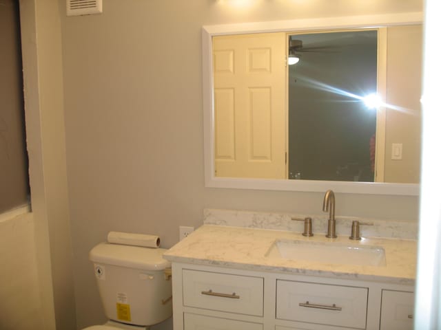 bathroom featuring vanity and toilet