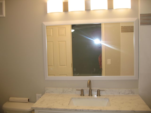 bathroom featuring toilet and vanity