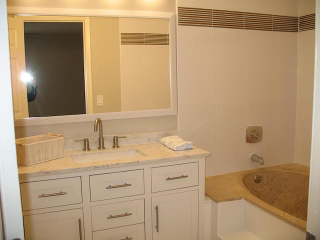 bathroom featuring shower / bath combination and vanity