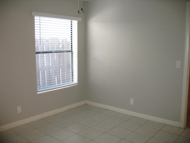 unfurnished room with a healthy amount of sunlight and baseboards