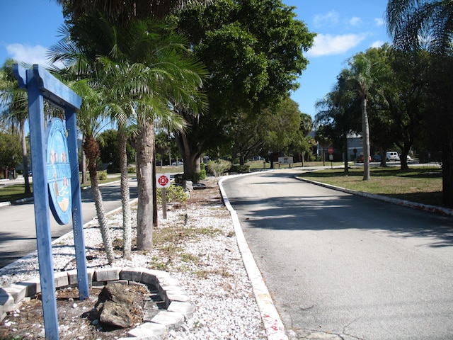 view of street with traffic signs and curbs