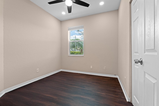 spare room featuring dark hardwood / wood-style flooring and ceiling fan