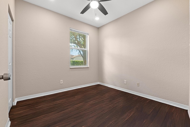 empty room with hardwood / wood-style floors and ceiling fan