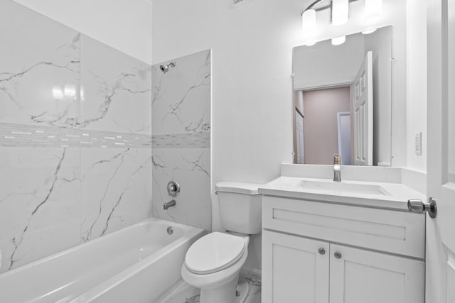 full bathroom featuring tiled shower / bath, vanity, and toilet