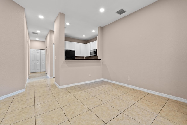 spare room featuring light tile patterned floors