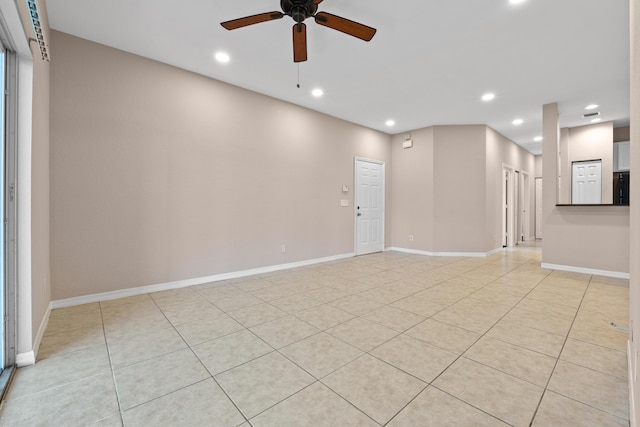 spare room featuring ceiling fan and light tile patterned floors