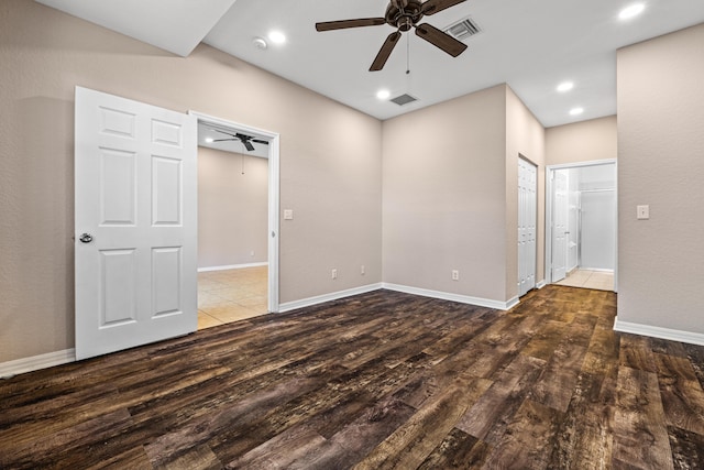 unfurnished room with ceiling fan and dark hardwood / wood-style flooring