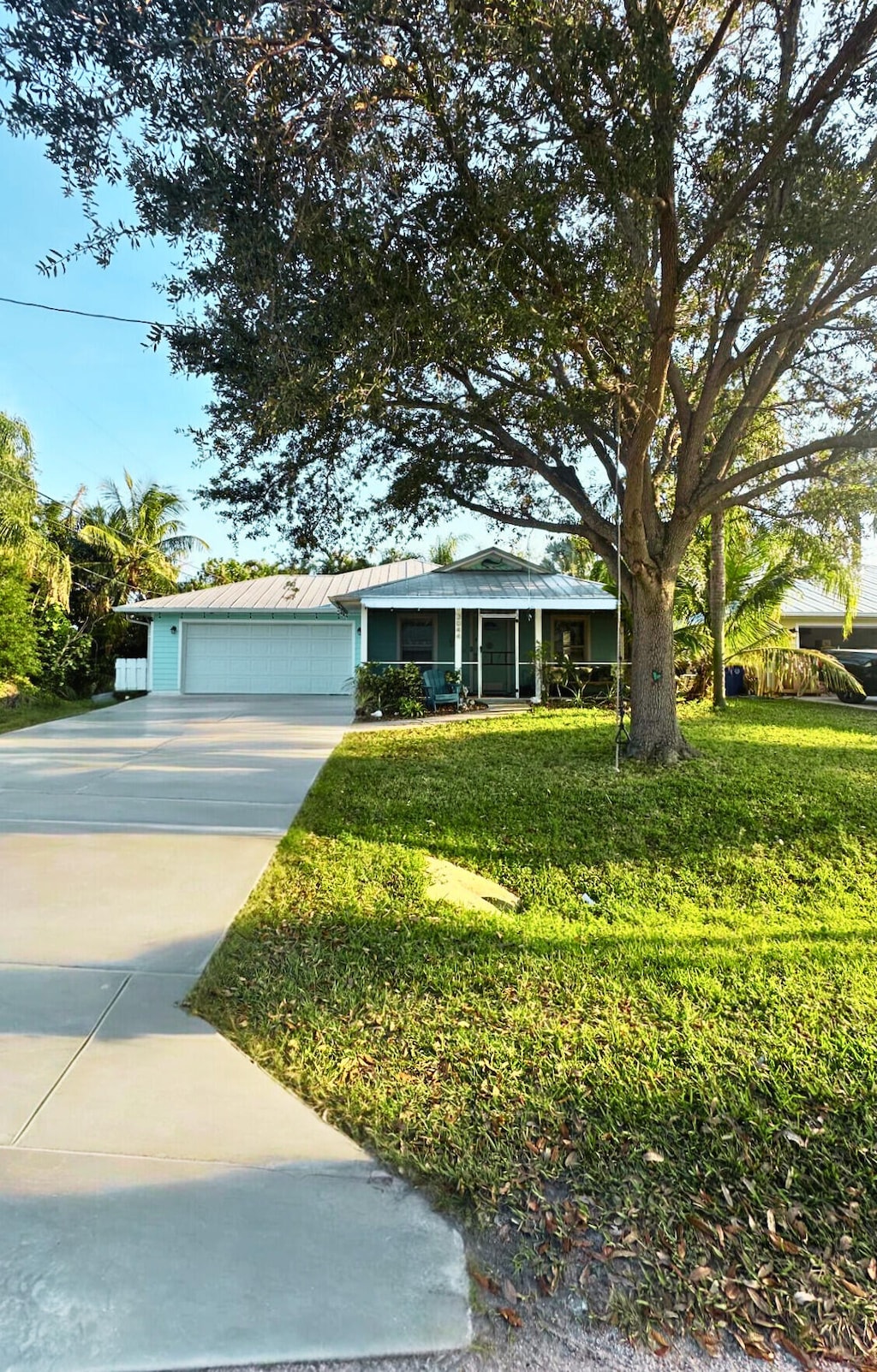 view of front of home with a garage and a front lawn