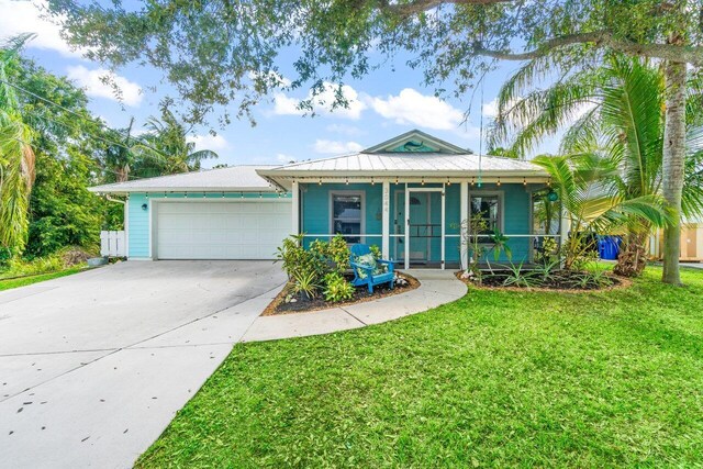 view of front of home with a garage and a front lawn