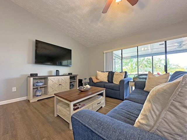 living room featuring ceiling fan, lofted ceiling, dark hardwood / wood-style floors, and a textured ceiling