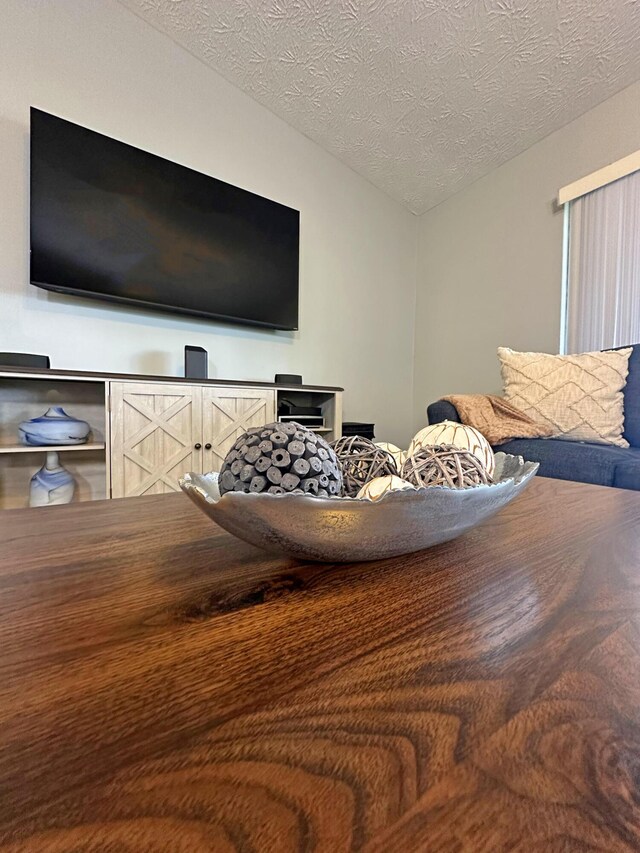 bedroom featuring lofted ceiling and a textured ceiling