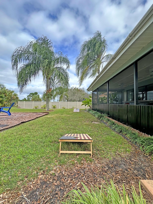 view of yard with a sunroom