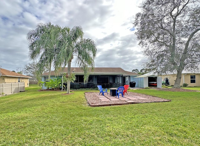 back of house featuring a patio, an outdoor fire pit, and a lawn