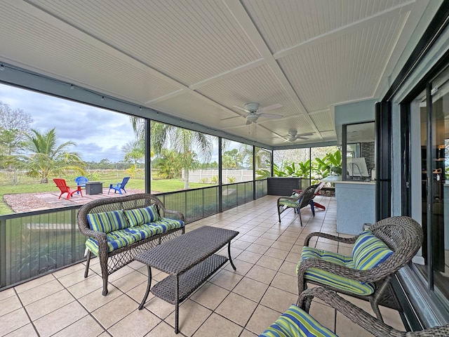 sunroom / solarium featuring ceiling fan