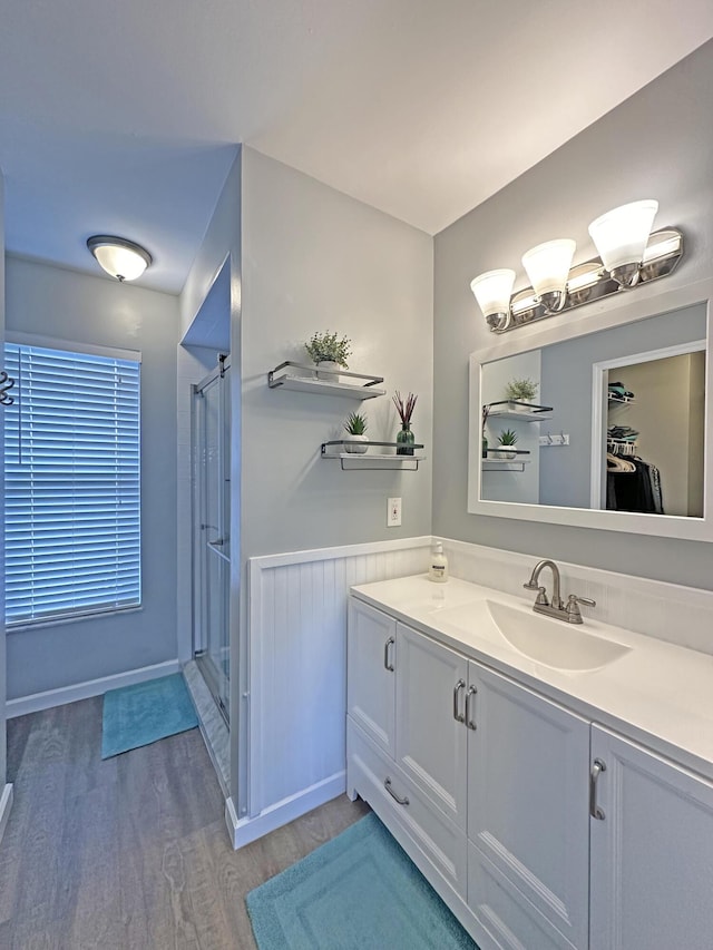 bathroom featuring vanity, hardwood / wood-style floors, and a shower with shower door