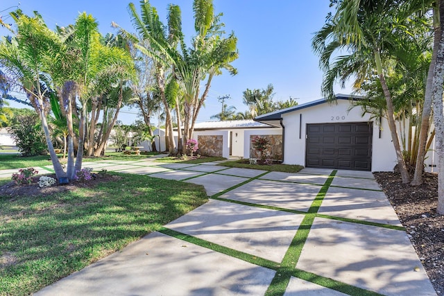 view of front of home featuring a garage and a front lawn