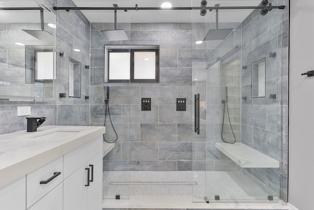 bathroom featuring vanity and a shower with door