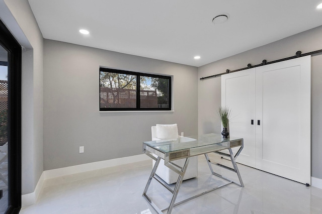 office space featuring a barn door and a healthy amount of sunlight