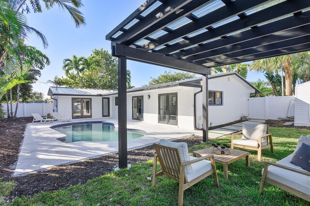 view of swimming pool featuring a pergola, an outbuilding, and a patio