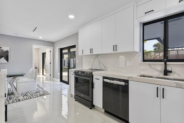 kitchen featuring range with electric stovetop, tasteful backsplash, white cabinetry, black dishwasher, and sink