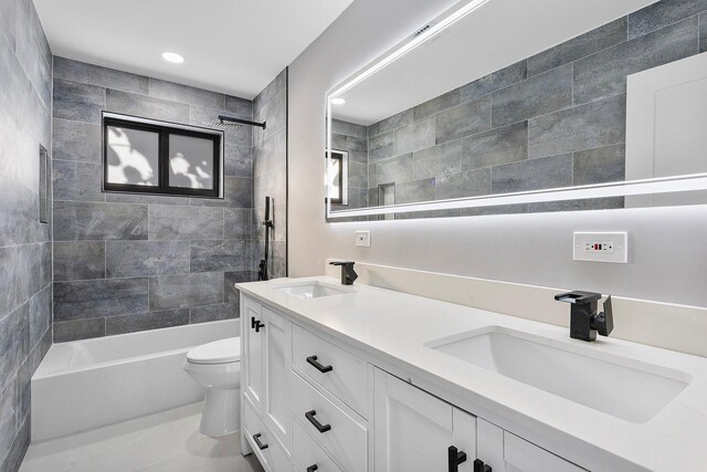 full bathroom with vanity, tiled shower / bath, and toilet