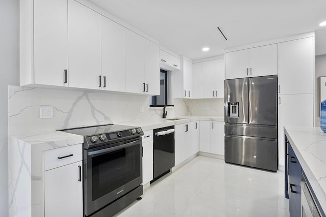 kitchen with appliances with stainless steel finishes, sink, white cabinets, backsplash, and light stone countertops