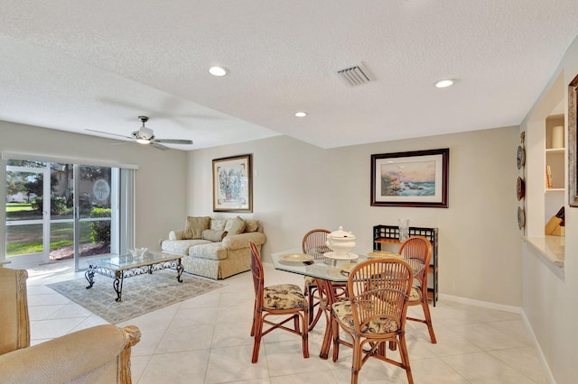 dining area featuring ceiling fan, a textured ceiling, and light tile patterned flooring