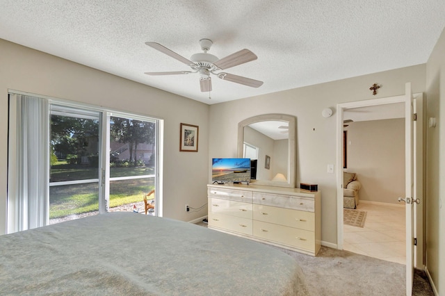 carpeted bedroom with ceiling fan and a textured ceiling