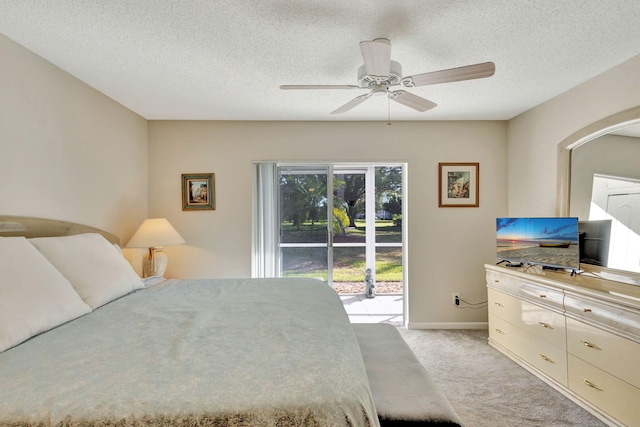 bedroom with ceiling fan, a textured ceiling, light carpet, and access to outside