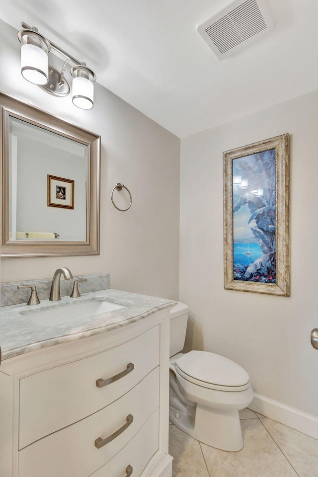 bathroom featuring tile patterned flooring, vanity, and toilet