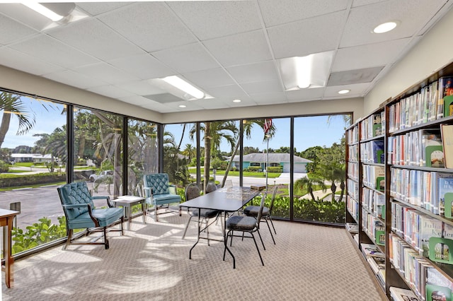 unfurnished sunroom featuring a drop ceiling