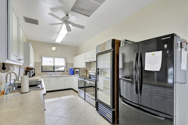 kitchen featuring light tile patterned flooring, sink, appliances with stainless steel finishes, ceiling fan, and white cabinets