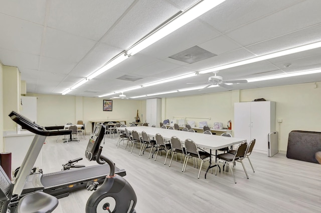 workout area featuring light hardwood / wood-style flooring and a paneled ceiling