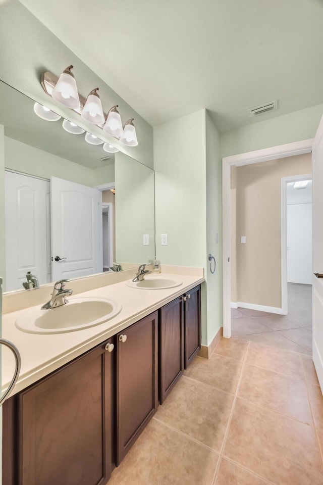 bathroom with tile patterned floors and vanity