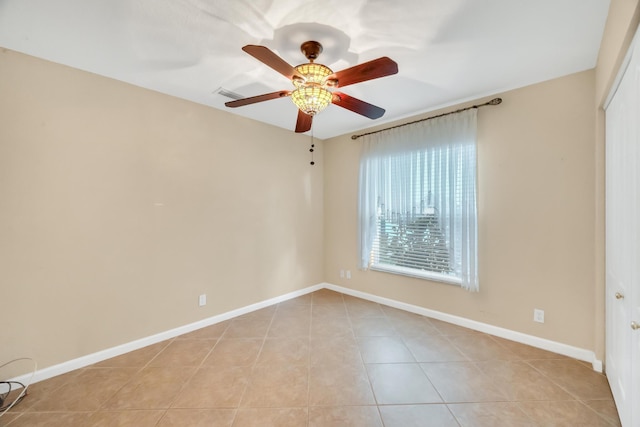 unfurnished room featuring ceiling fan and light tile patterned floors